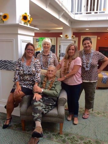Amy with fellow staff members and a resident